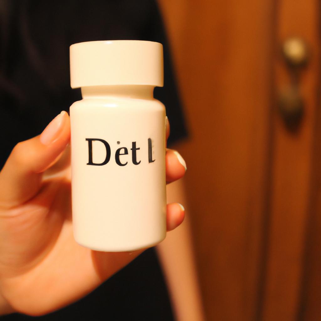 Person holding diet pill bottle